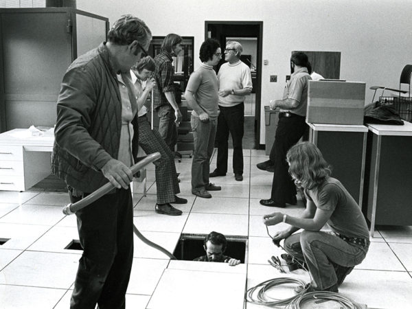 Employees of computing services at SUNY Potsdam installing a mainframe computer in Potsdam