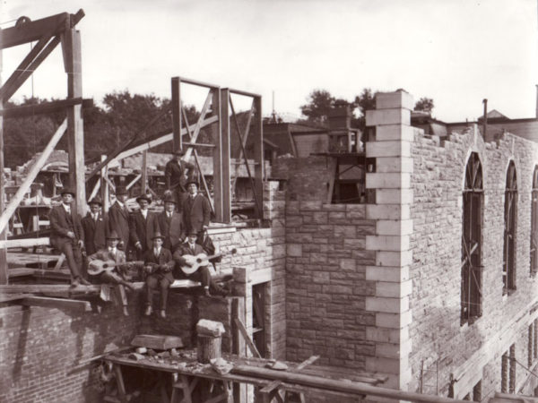 Men in suits at construction site of Potsdam Normal School in Potsdam