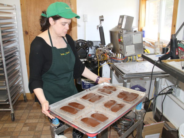 Deb Morris removing air from chocolate at Barkeater Chocolates in North Creek