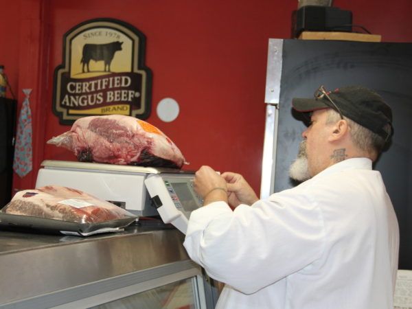 Pricing meat in Walker's Neighborhood Butcher Shop in Lake Placid