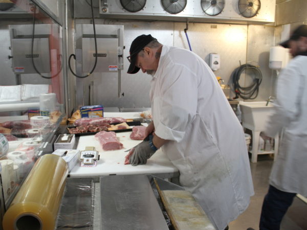 Cutting meat in Walker's Neighborhood Butcher Shop in Lake Placid