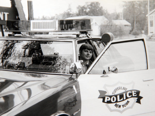 Officer Tom Proulx in a Tupper Lake Police Department vehicle in Tupper Lake