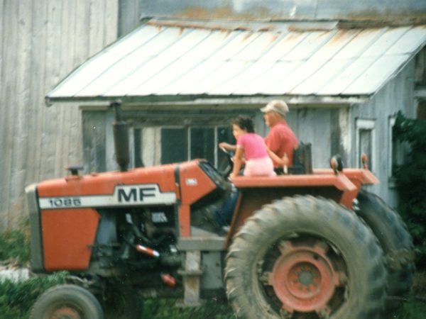 Driving a Massey Ferguson 1085 tractor on the Cuthbert Farm in Hammond