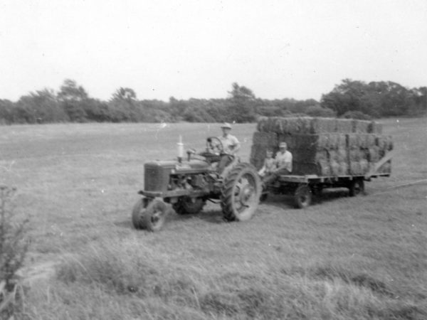 Moving hay bales with a Farmall tractor in Hammond