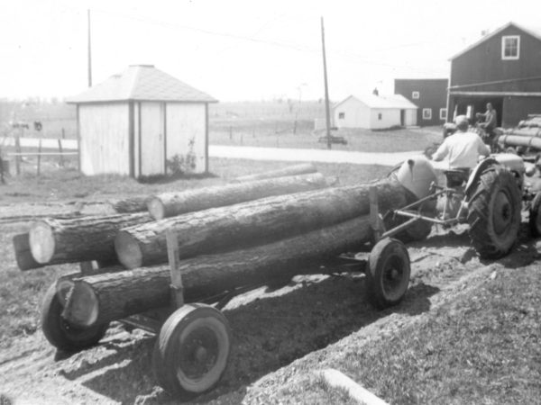 Hauling logs with a Ford tractor on the Paddock farm in Hammond