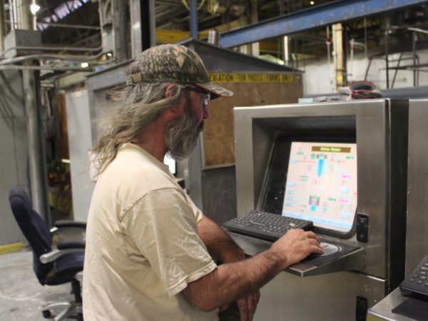 Man inside the Potsdam Specialty Paper Company in Potsdam