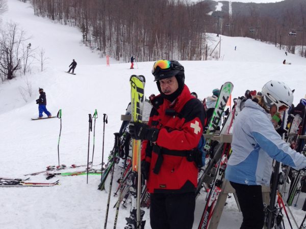 Ski patroller Rick Wood holds skis on Whiteface Mountain in Wilmington