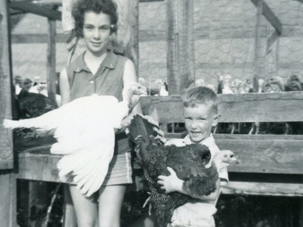 Jane and Thompson with their family’s turkey flock in Heuvelton