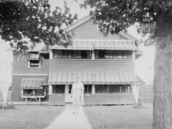 Alice Keough standing in front of her summer motel in Saranac Lake