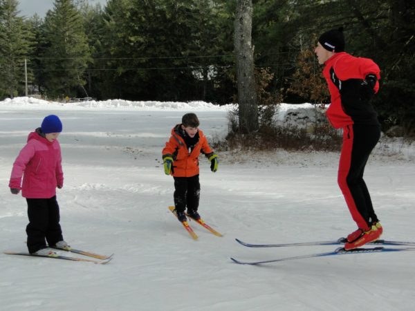 Oaul Ferri teaching children to nordic ski in Benson