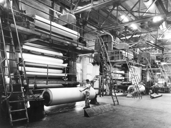 Worker at a super calendar machine at the St. Regis Paper Company mill in Deferiet