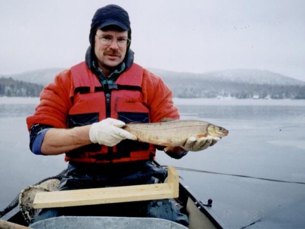 Dan Josephson holding an endangered fish in Old Forge