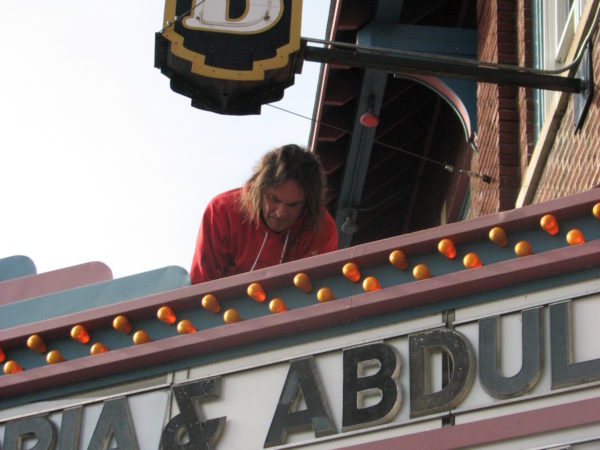 Bob Card works on the marquee of The Strand theater in Old Forge