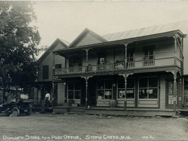 Man and automobile outside Dunlop’s Store and Post Office in Stony Creek