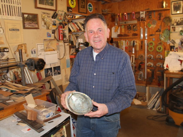 Dave Nichols holding a shell he uses to inlay guitars