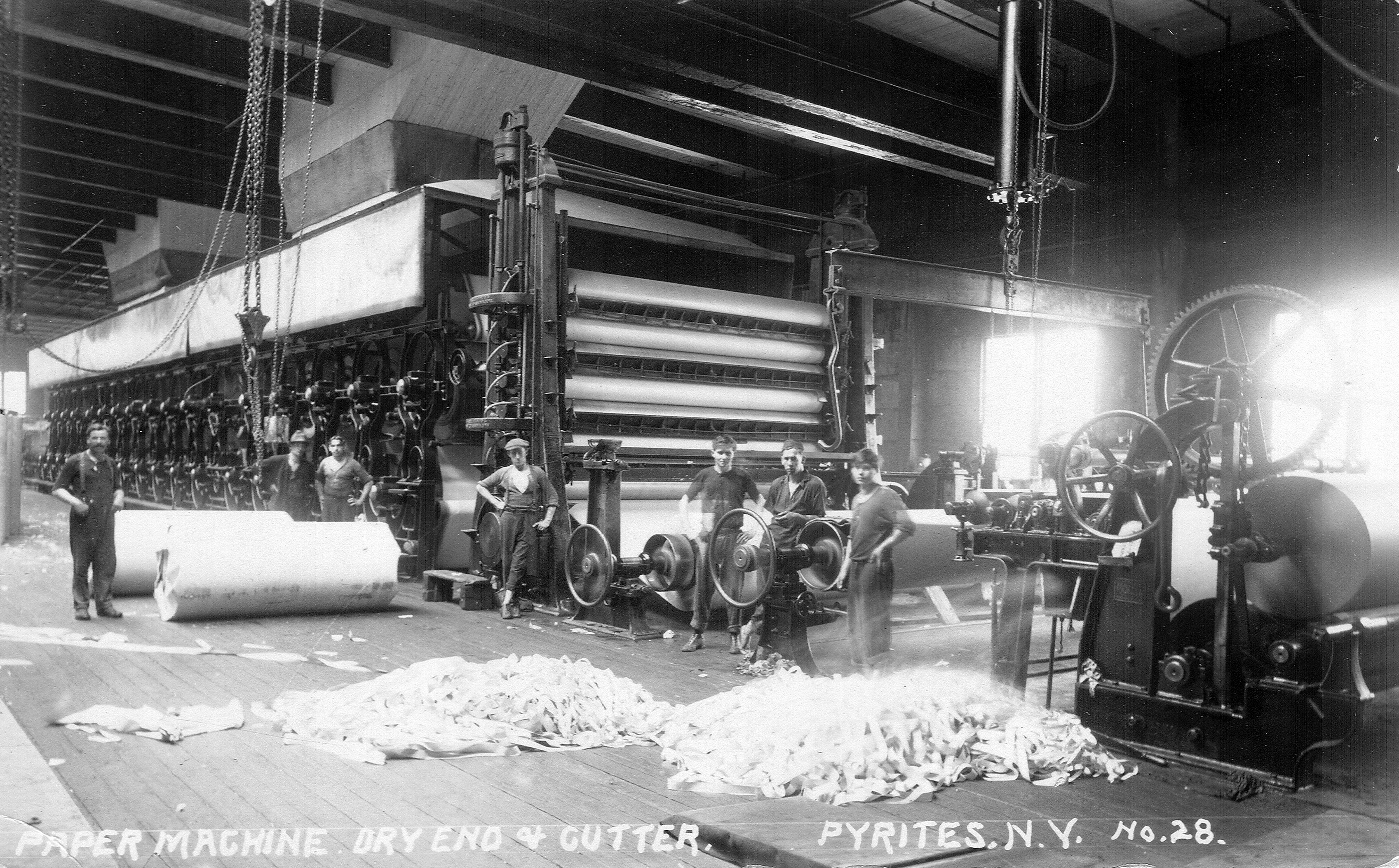 Men with paper machines inside the DeGrasse River Paper Company in
