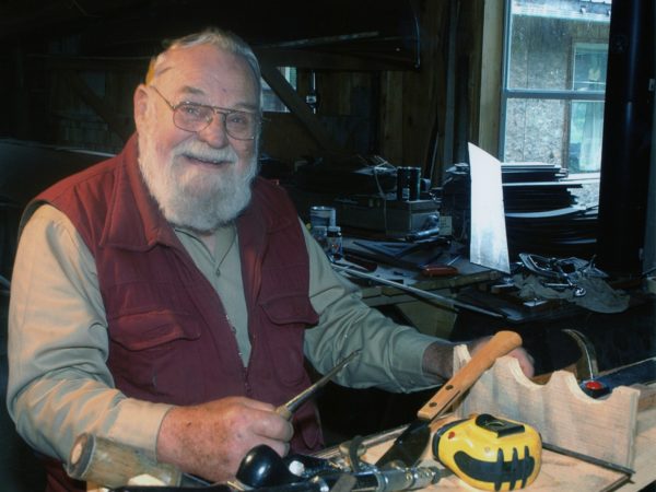 Herald Austin works on a guideboat in his shop in Long Lake