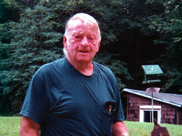 Lumberjack Louis Wright holding his first marking axe in Long Lake