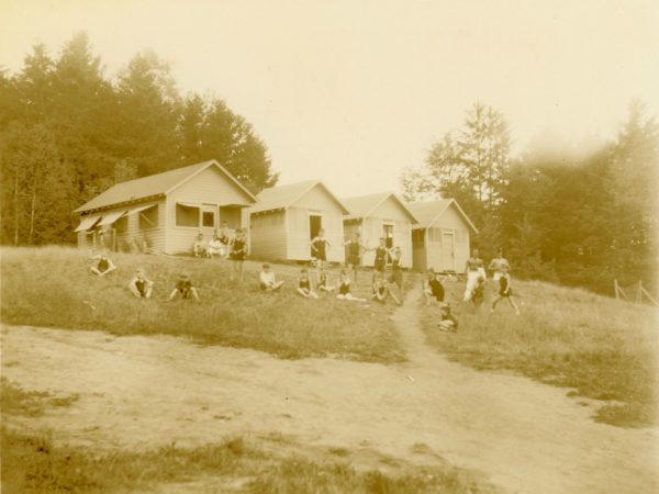 Children in front of the bunks at Camp Beattie in Long Lake