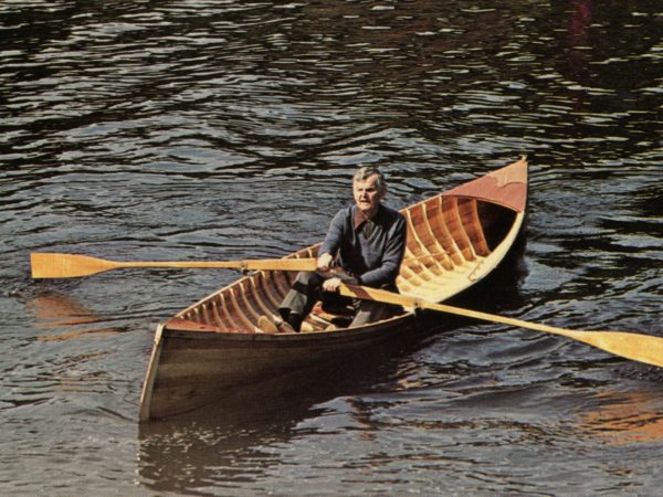 Fred Burns rowing a guide boat in Long Lake