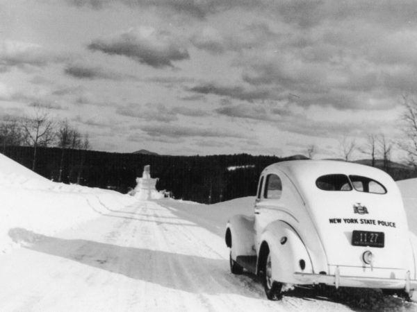 New York State Trooper automobile on snowy road in Long Lake