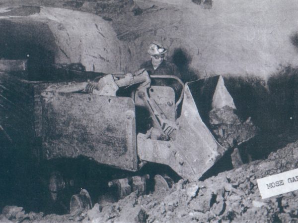 Mose Garrow loading ore into tram cars in Lyon Mountain