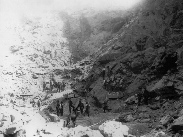 Men mining iron ore at an open pit mine in Lyon Mountain