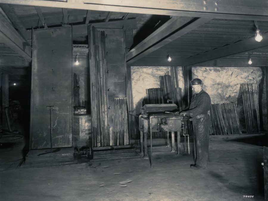 Men mining iron ore at an open pit mine in Lyon Mountain