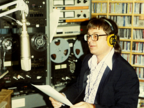 NCPR announcer Peter Euler reads into microphone at studio in Canton