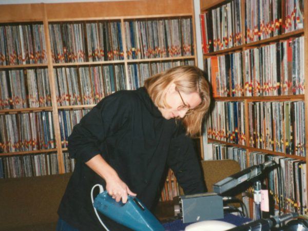 Martha Foley vacuums in the record room at NCPR in Canton