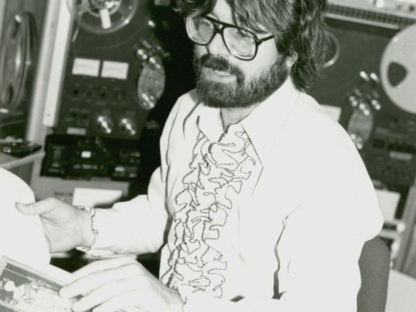 NCPR announcer Peter Euler reads into microphone at studio in Canton