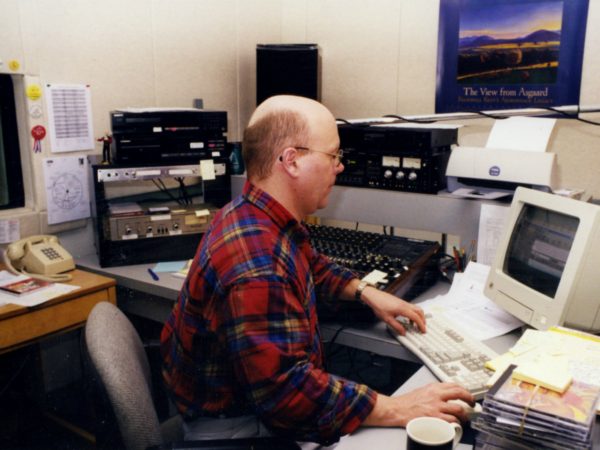 Morning show host Todd Moe works at computer at NCPR in Canton