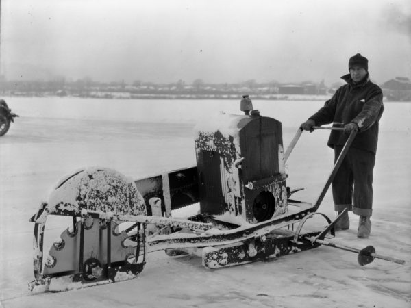 Man operating ice cutting machine on Plattsburgh Bay