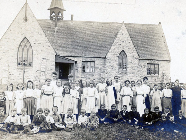 Schoolchildren and teacher outside the Morley Schoolhouse