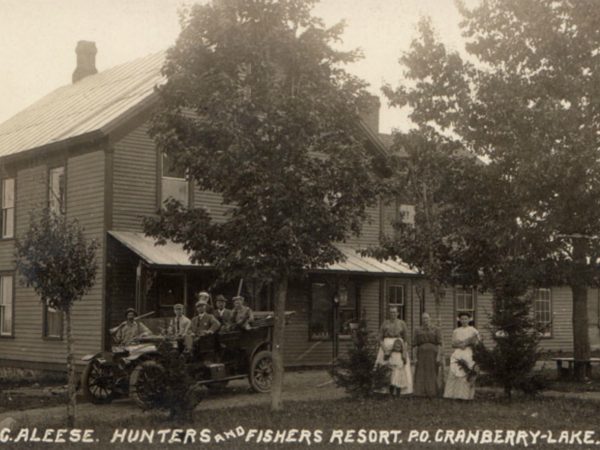 Employees with hunting expedition in front of Mountain House of Windfall in Cranberry Lake