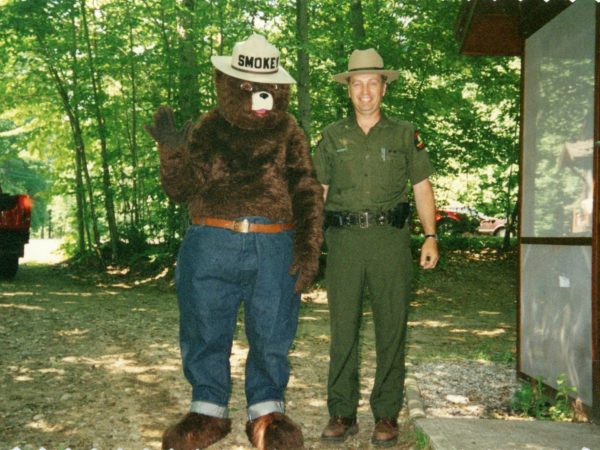 Forest ranger with Smokey the Bear at a campground in Cranberry Lake