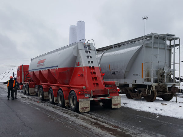 Fly ash being trans-loaded from rail cars to trucks at Seaway Bulk Services