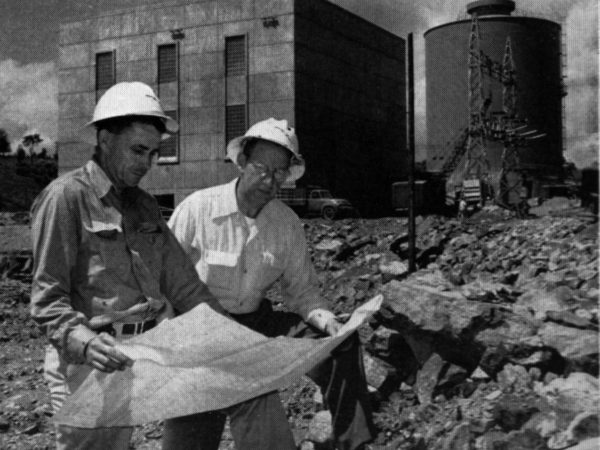 Meryl Morris and Alan Willard anaylzing hydro-electric plant blueprints in South Colton