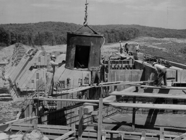 Workers using machinery to build Ranbow Falls Dam