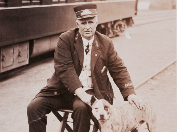 A train conductor with the station dog in Clayton