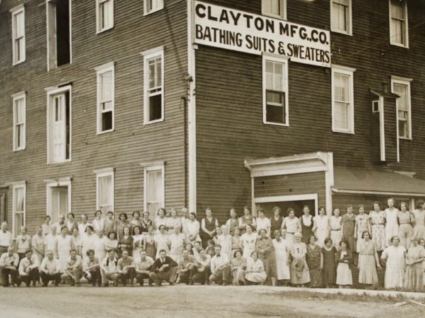 Workers pose outside the Clayton Manufacturing Company in Clayton