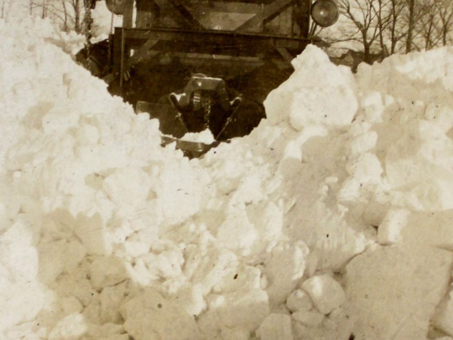 Employees of Frink Snowplows stand next to Vplow in Clayton