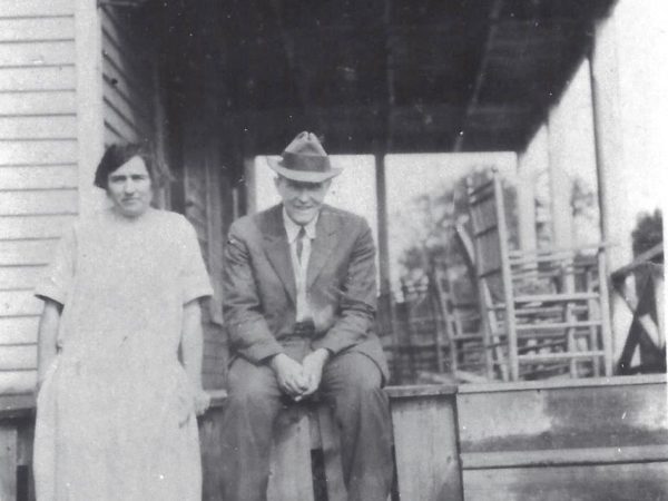 Two men in front of Avery’s Inn in Piseco