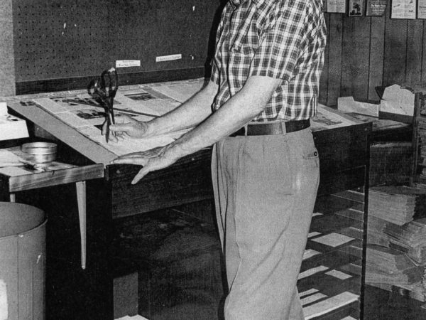 Ray Hansen pasting up the front page of the Carthage Republican Tribune in Carthage