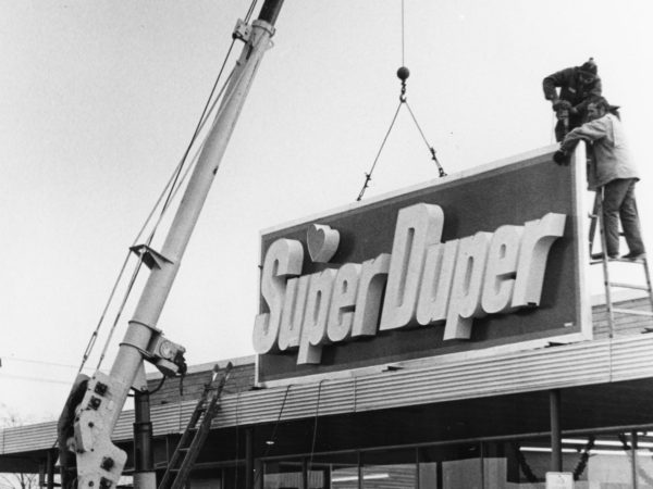 Putting the sign on the Super Duper in West Carthage