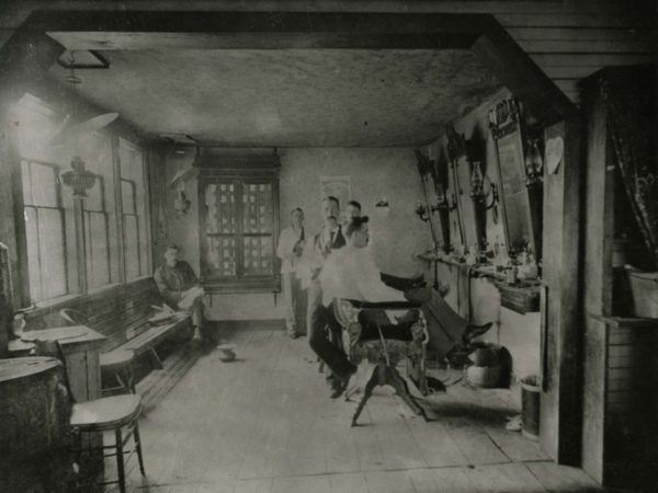 Men inside the first barbershop in Tupper Lake