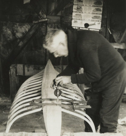 Wallace Emerson drilling holes in boat in Long Lake