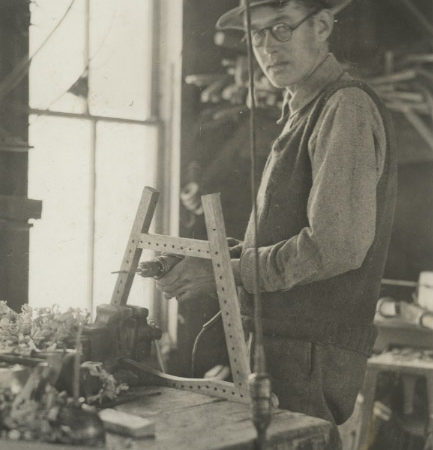 Wallace Emerson, Jr. at work in guideboat shop in Long Lake