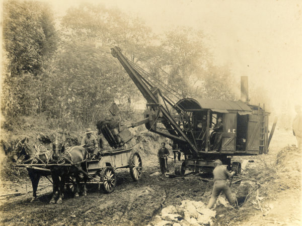 Workers build road using horses and steam shovel in Adirondacks