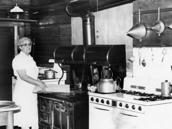 Woman in the kitchen of Camp Uncas in Racquette Lake